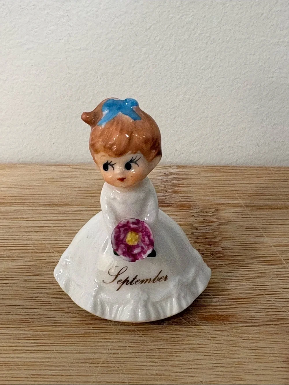 Napcoware September Ceramic Birthday Girl Figurine with Blue Bow and Pink Flower